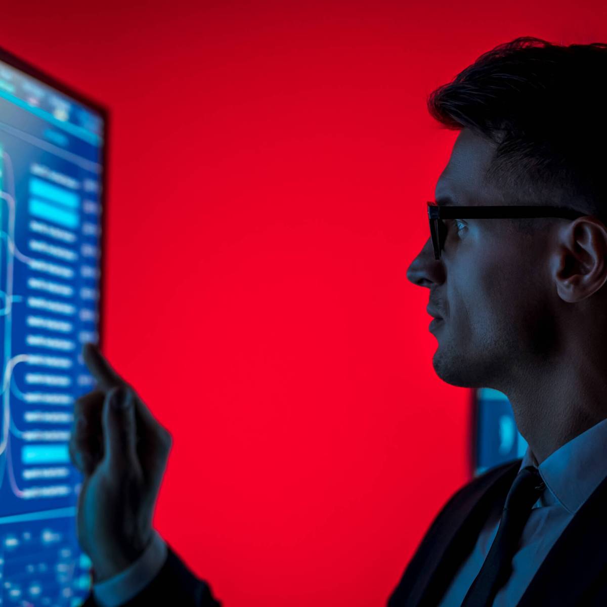 The man in suit taps on a blue sensor monitor